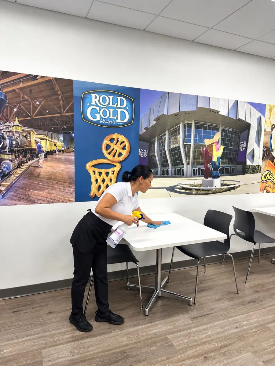 Employee cafeteria tables being sanitized