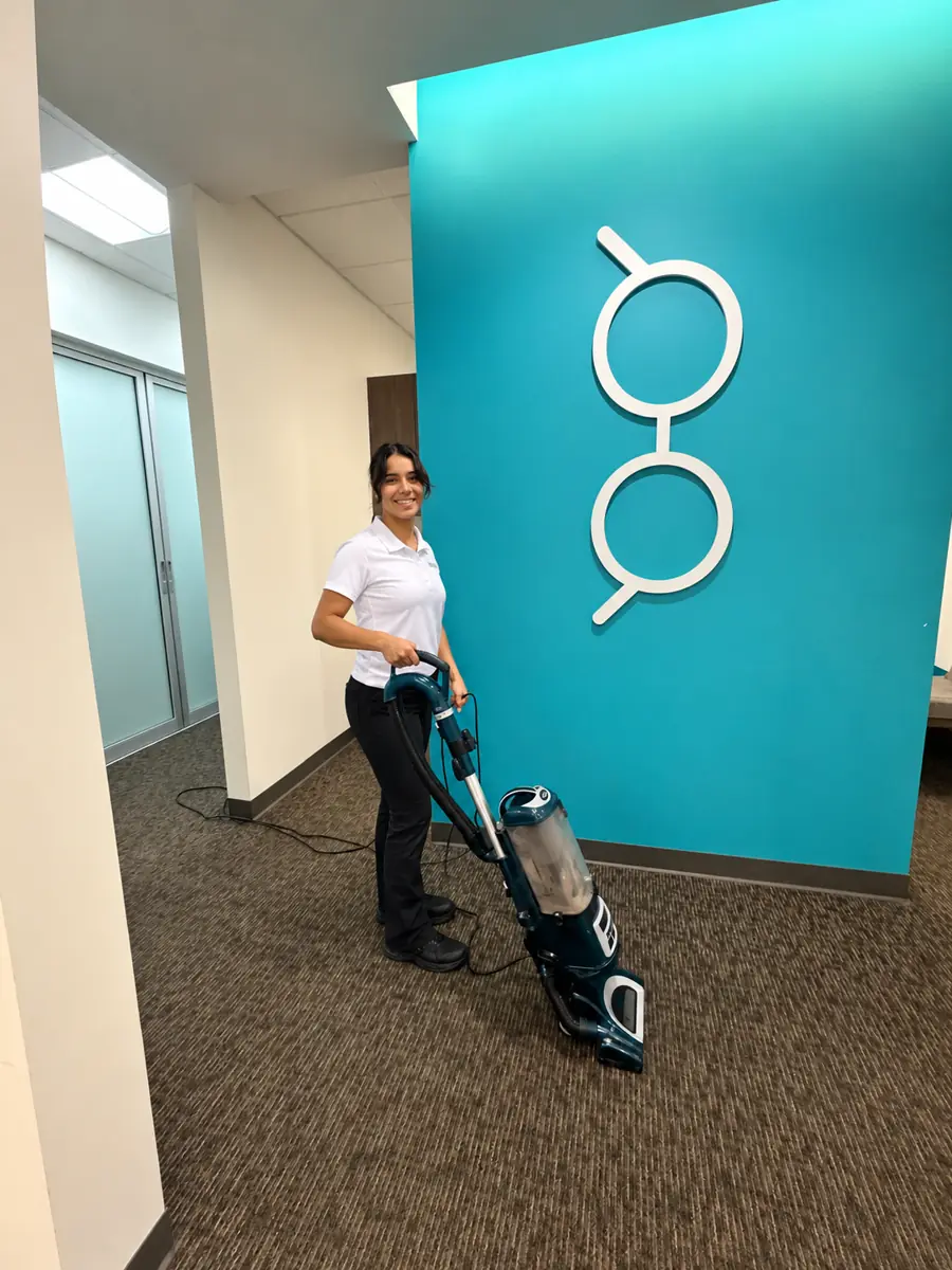 Team member vacuuming office lobby carpet