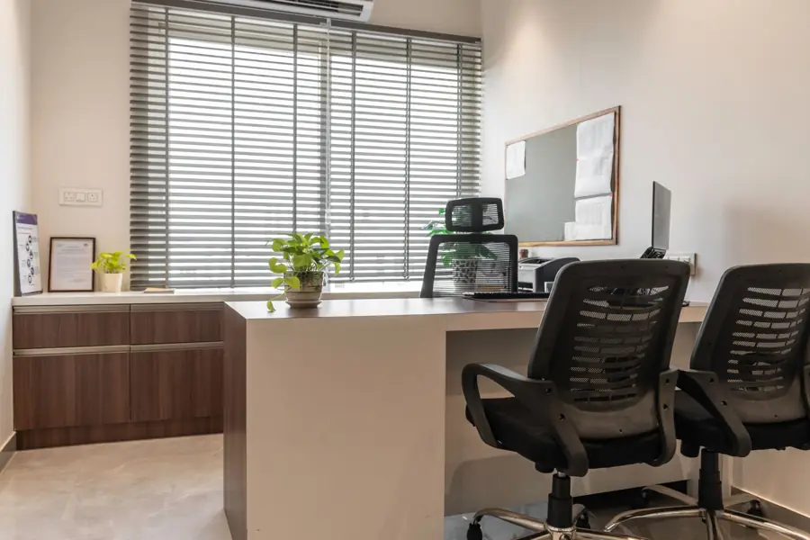 Clean private office suite with desk and chairs